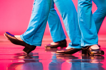 group of tap dancers feet on a shiny stage