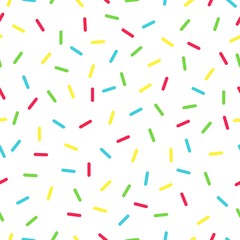 Seamless background with white donut glaze. Decorative bright sprinkles texture pattern design