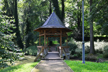 Bridge with the roof  /  Bridge with the roof above the creek in the spa park in Klasterec nad Ohri in Czech republic.