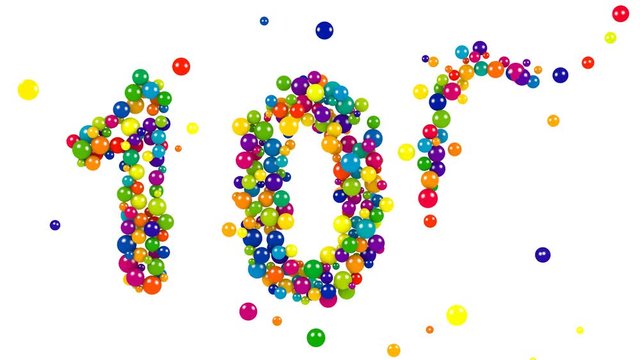 The number 100 formed of brightly colored spheres or balls in the colors of the spectrum for festive centenary celebrations or events on white with copy space