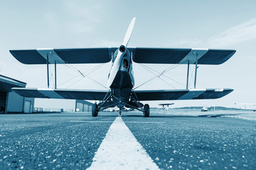 Historic aircraft biplane on runway, retro, blue colored