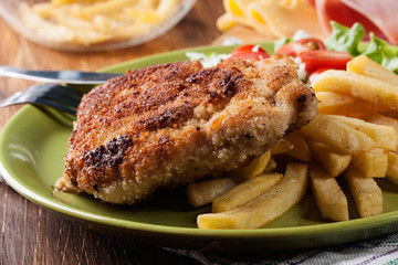 Cutlet Cordon Bleu with pork loin served with French fries and salad
