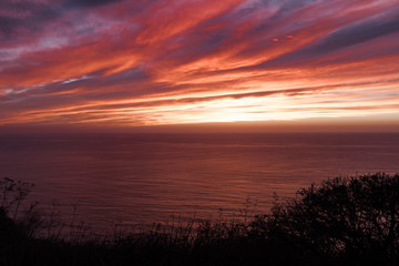 Dramatic sky as the sun disappears over the Pacific Ocean