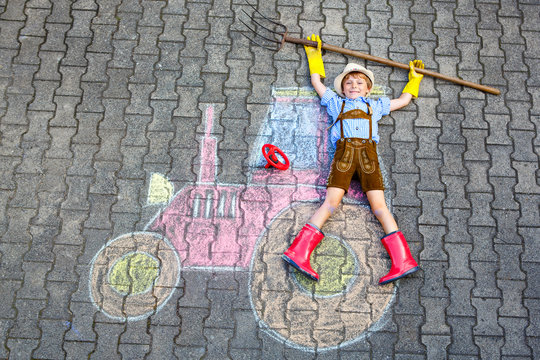 little kid boy having fun with tractor chalks picture 