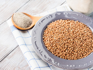 Buckwheat grain and flour. Closeup