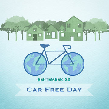 World Car free day on September 22 campaign with illustration of drawing of bicycle on road with world map wheels and clean environment of town with green trees on recycled paper texture background 