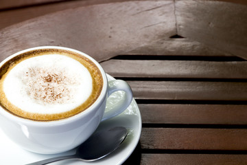 hot coffee and white cup on wood table