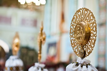 Golden cross with church element of stick throne at church