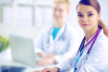 Medical team sitting at the table in modern hospital