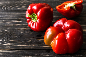 Red bell pepper on wooden background. Harvest