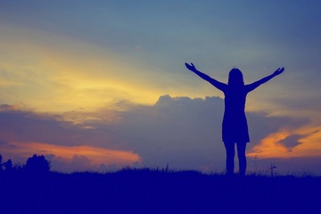 silhouette of woman happy alone at  sunset