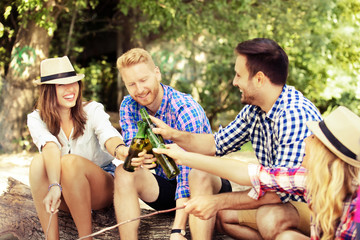 Friends enjoying camping and grilling sausages.