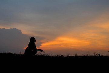 silhouette of woman Looking for a dream at sunset