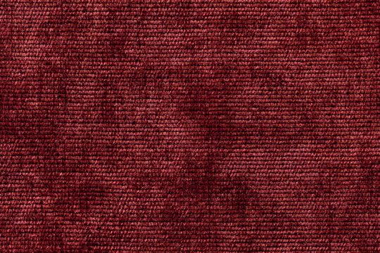 Dark red background from soft textile material. Fabric with natural texture.