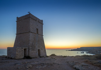 Malta, Ghajn Tuffieha Tower at sunset with clear blue sky at Golden Bay