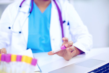 Woman researcher is surrounded by medical vials and flasks, isolated on white background