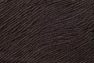 Dark brown background from soft textile material. Fabric with natural texture.