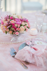 Table setting at a luxury wedding decorated with composition of