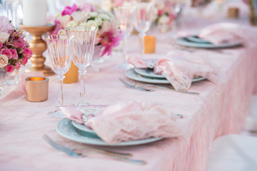 Table setting at a luxury wedding decorated with composition of