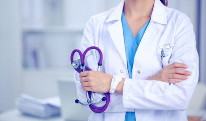 Portrait of happy successful young female doctor holding a stethoscope