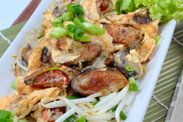 Close up of fried oyster with bean sprouts and shallot as 