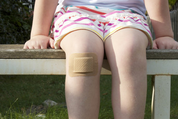Girl with big plaster on her knee