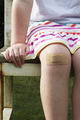 Girl with big plaster on her knee