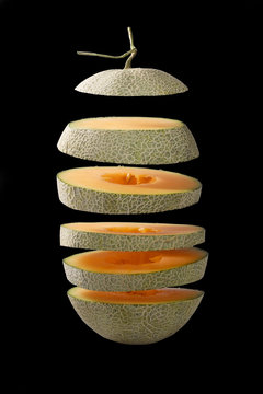 Flying slice of melon on black background. Isolated and clipping path.