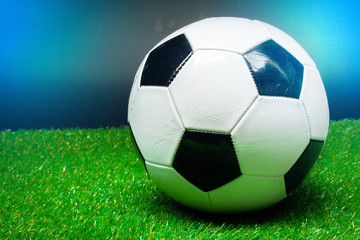 Naklejka premium soccer ball on the green field