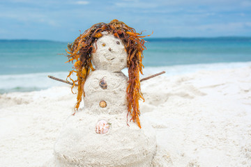 Redhead sand man on tropical beach with white sand and blue sea. Children games during summer vacation
