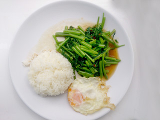 Food Thai in Asian, Stir Fried Water Spinach with rice on white plate,  Vegetarian Food, healthy food