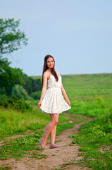 girl in white dress in field