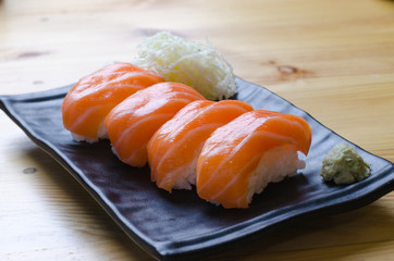 Fresh japanese salmon sushi on wood table
