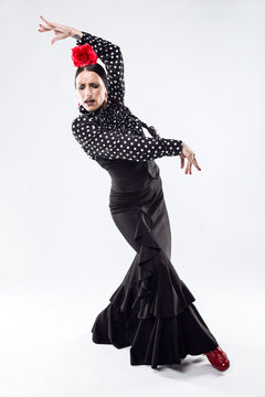 Pretty young flamenco dancer in beautiful dress.