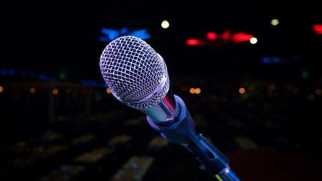 microphone stand on the stage venue with blur bokeh background