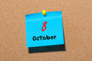 October 8th. Day 8 of month, color sticker calendar on notice board. Autumn time. Empty space for text