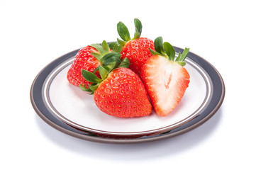 fresh garden strawberries on a white plate