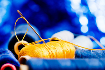 needle and yellow thread