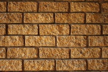Decorative ocher brick wall on a house exterior
