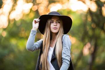 beautiful girl in black hat, outdoors