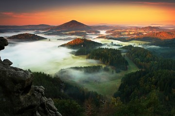 Czech typical autumn landscape. Hills and villages with foggy morning. Morning fall valley of Bohemian Switzerland park. Hills with fog, landscape of Czech Republic, landscape from Ceske Svycarsko. 