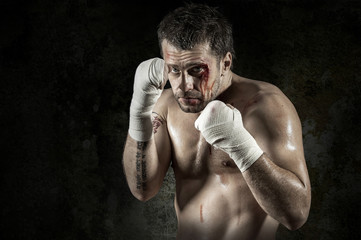 Fototapeta na wymiar Portrait of aggressiv boxer in blood