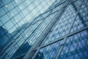 Perspective and underside of contemporary glass building skyscrapers at night