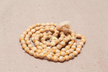 Closeup of rolled chanting beads on woolen texture