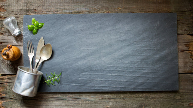Old retro culinary menu abstract background on black stone
