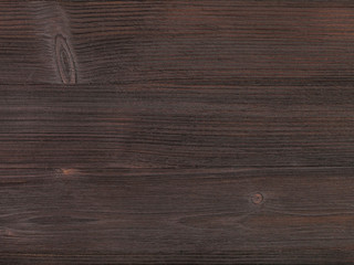 wooden surface of dark brown color close up