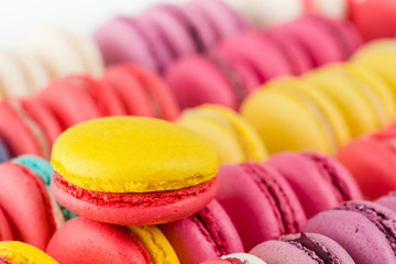 closeup French dessert macaroon on a background of colorful cake