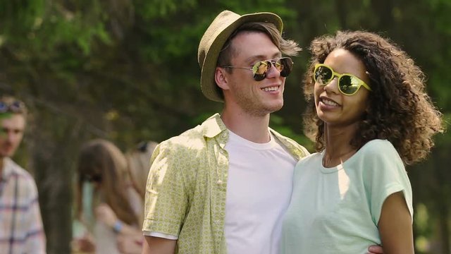 Smiling man and woman making funny faces, pouting for selfie on smartphone