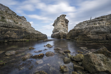 Fototapeta na wymiar huge rocks on the sea with long exposure shot