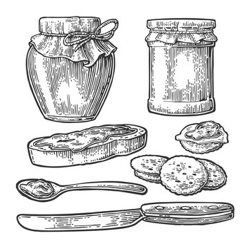 Jar, spoon, knife and slice of bread with jam.